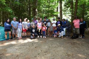 Group of men women and children first time campers