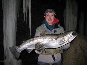 Female angler holding up steelhead