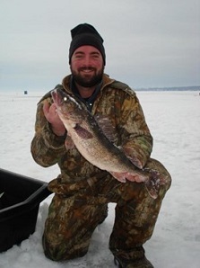 Ian holding up Walleye while ice fishing