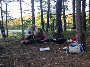 Camp counselor with campers in the woods