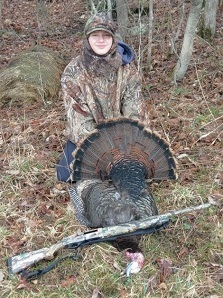 Youth hunter poses with harvested turkey