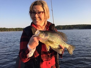 Female angler holding up crappie