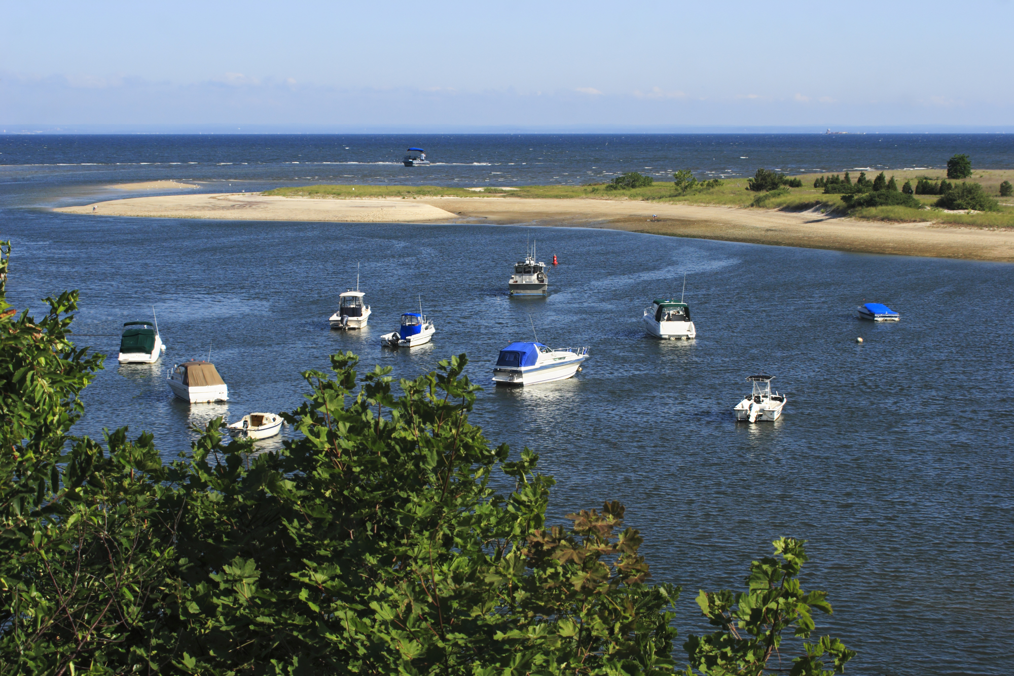 Recreational boats on anchored around a coastal shoreline