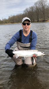 Female Angler holding up Atlantic Salmon