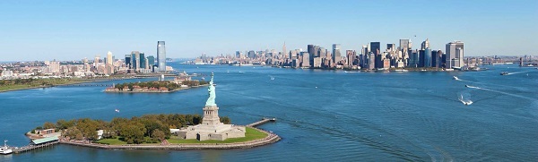 aerial view of New York Harbor with Statue of Liberty in the foreground