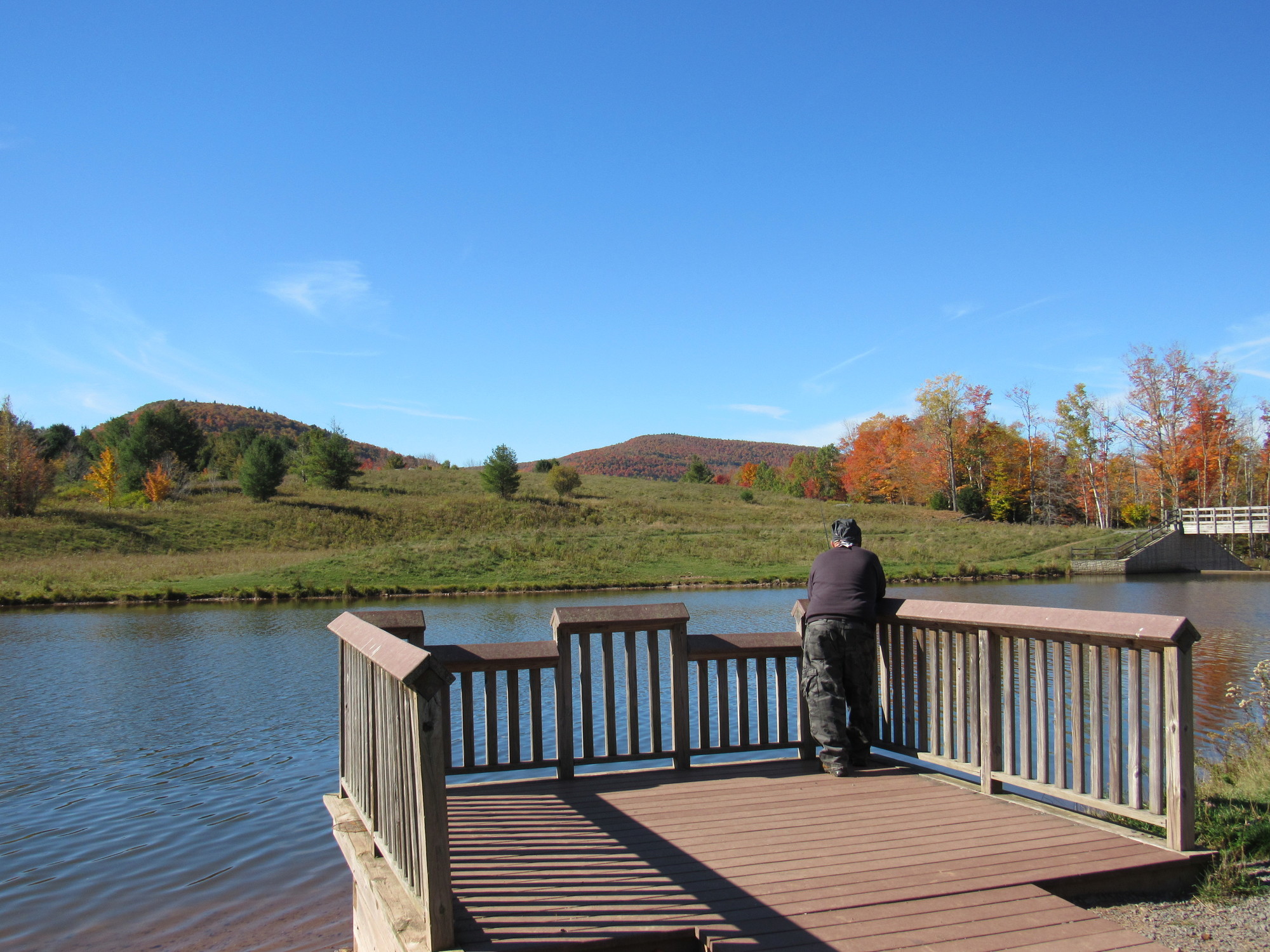 Person fishing from the Colgate Lake platform.