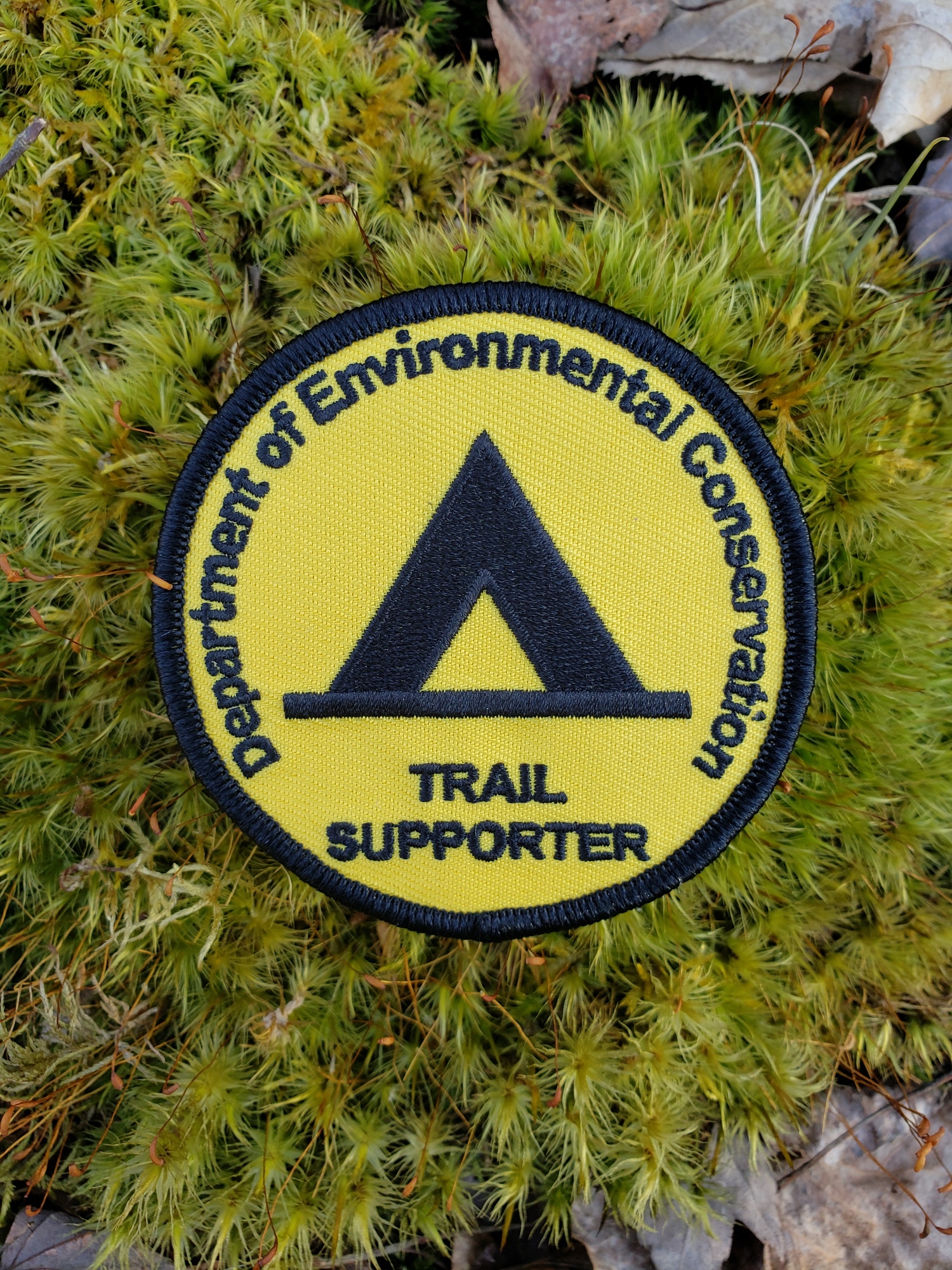 Camping patch with tent symbol on yellow background