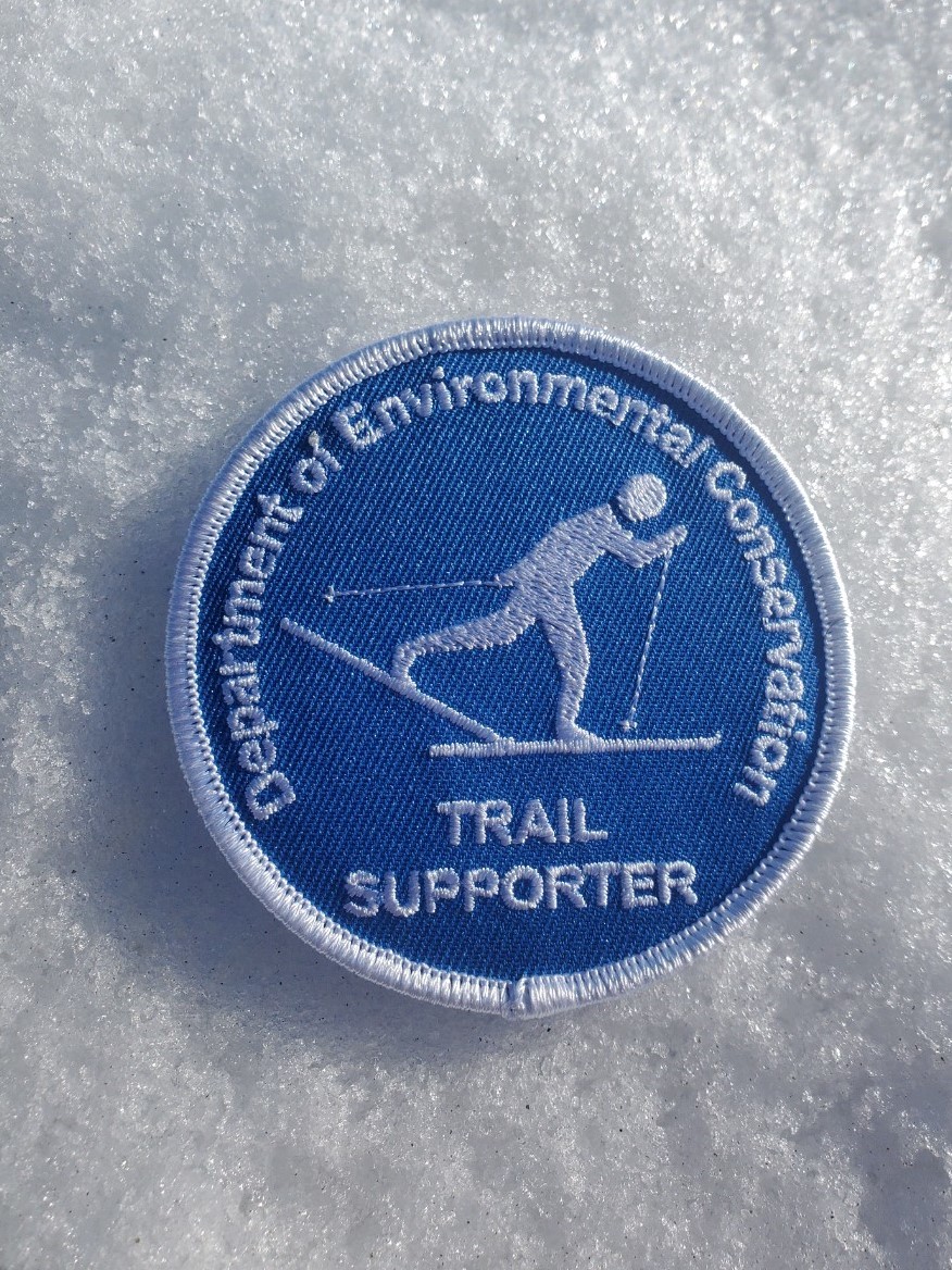 Cross-country skiing patch with skier on blue background