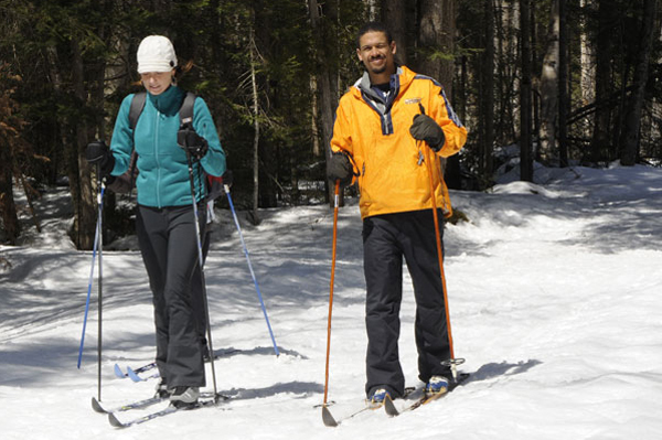 Two individuals cross-country skiing at a Camp Santanoni Weekend