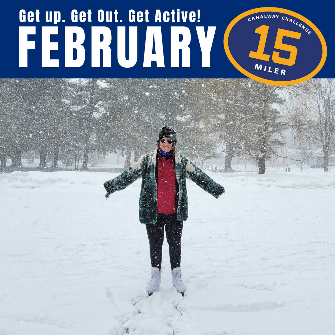 A woman standing in the snow with heavy snow falling around her on an Erie Canal towpath