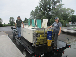 Hatchery crew with their fish stocking containers