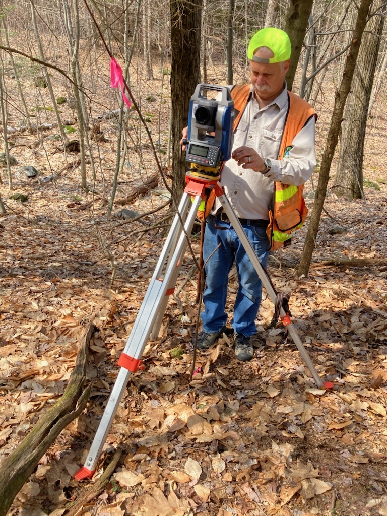 DEC’s employee surveying land in Rensselaer County