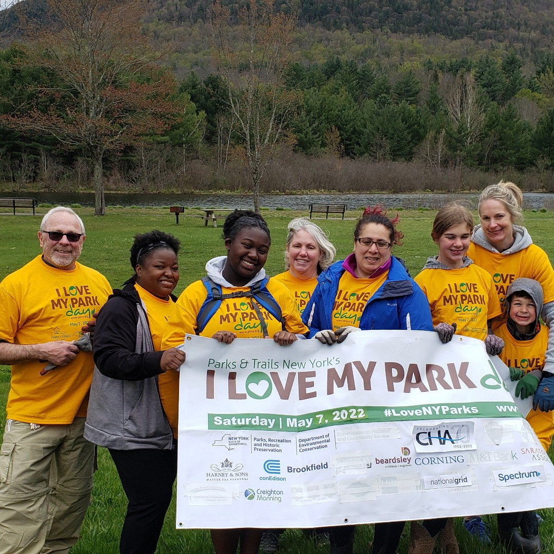 A group of volunteers standing in front of an I Love My Park Day sign