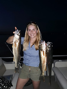 Fish Culturist Katie Williams holding fish