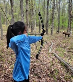 Person doing archery and holding a bow