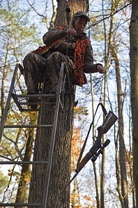 Hunter in Tree Stand with Safety Gear Hunter in Tree Stand with Safety Gear