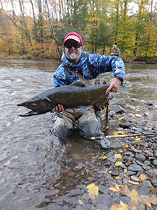 Angler holding a Chinook salmon