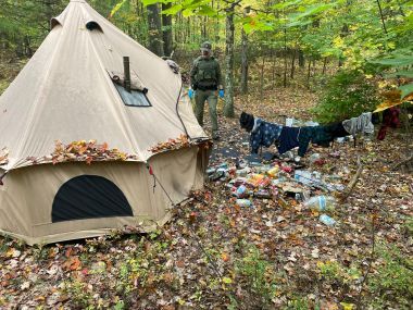 Ranger walking around illegal campsite