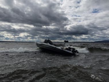 stranded boat in rocky waters