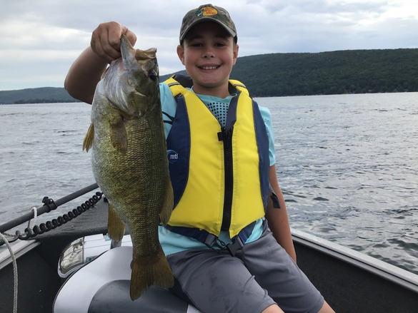 young angler holding a smallmouth bass