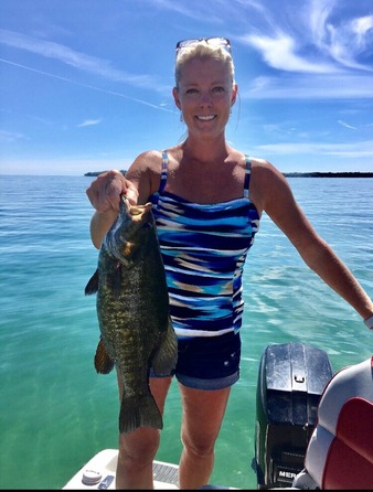 Angler holding smallmouth bass on Lake Erie