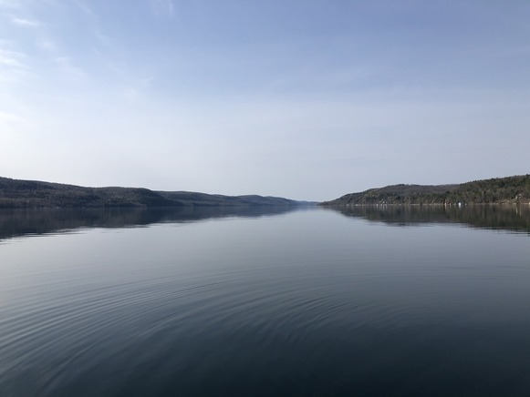 body of water (Otsego Lake) with rolling mountains in background
