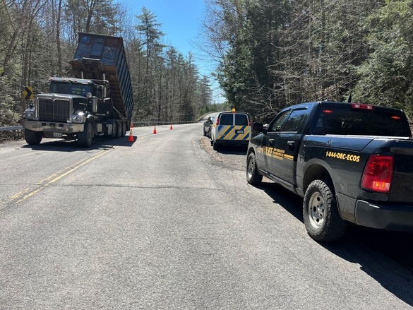 An Environmental Conservation Officer stopping a heavy-duty diesel vehicle