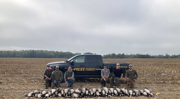 ECO Okonuk poses with goose hunters after compliance check in Franklin County