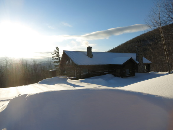 Cabin surrounded by snow.