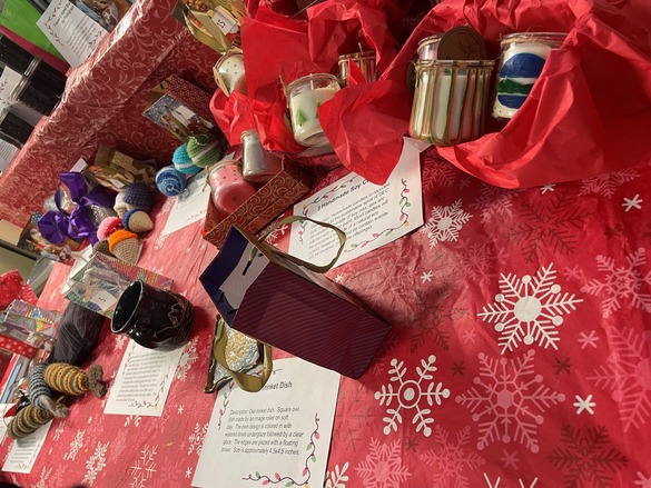 Table filled with holiday raffle items.