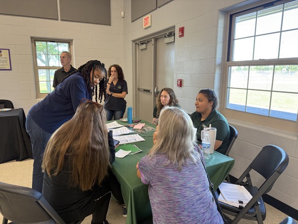 Picture of DEC and EPA staff at a recent NECRA tabling event, speaking with the public.
