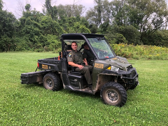 Two Environmental Conservation Officers in a Utility Terrain Vehicle