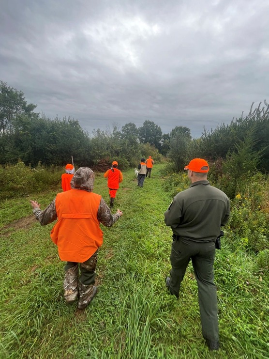 People in hunting gear in a field