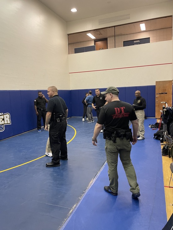 Rangers in a gymnasium standing on blue mats during training