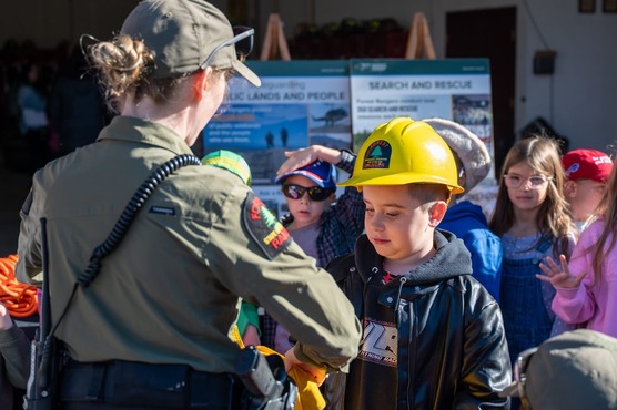 Ranger instructing child outdoors