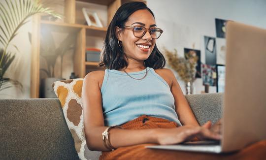 Woman smiling while using laptop