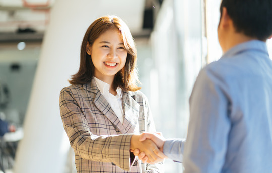 Female real estate agent shaking hands