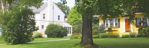 photo of yellow house and white house