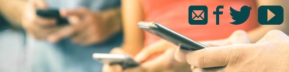 Hands holding phone with facebook, twitter, and youtube, and email symbols in upper-right