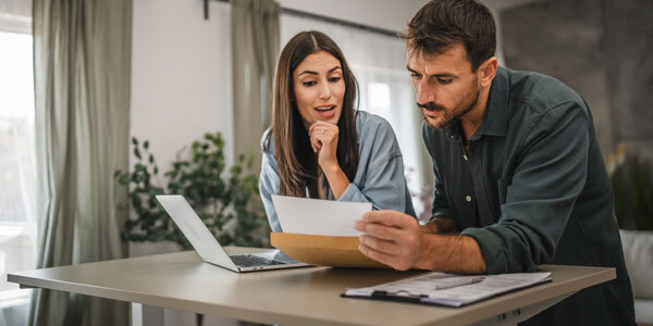 Couple reviewing letter they received from the Tax Department