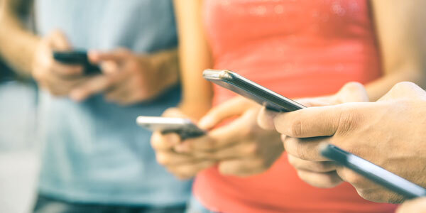 people on their phones connecting with the Tax Department on Facebook and X