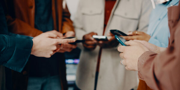 Group of individuals using phones
