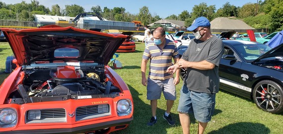 Supervisor Albra and Councilman Brachfeld talk gear ratios as they peruse a classic Trans Am at the car show last summer.
