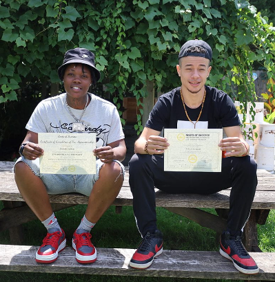 Zutiyah and Sunny holding their certificates