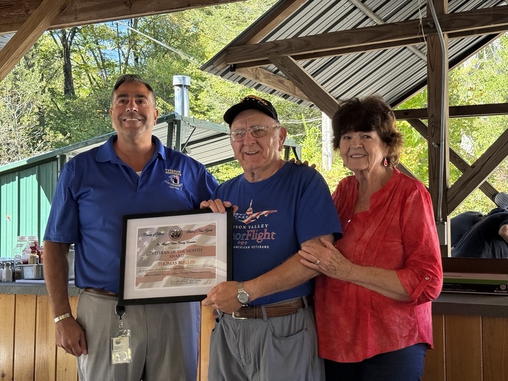 Director of Veteran Services Mark Cozzupoli presenting Tom Buglisi the Veteran of the Month Award, alongside Tom's wife Dorothy Buglisi