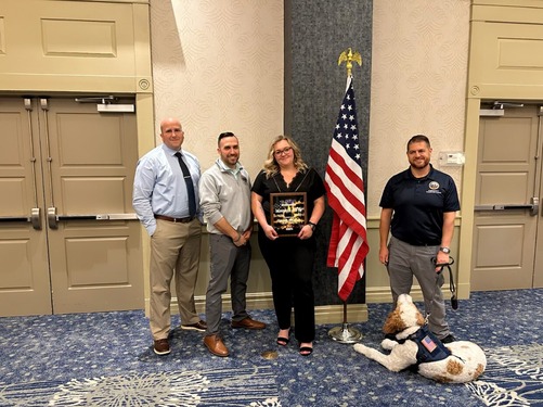 Hannah Hoffman with Emergency Services Director Everett Erichsen and Oliver the Mental Health Dog