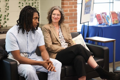 County Executive Metzger sitting with a SUNY Reconnect student