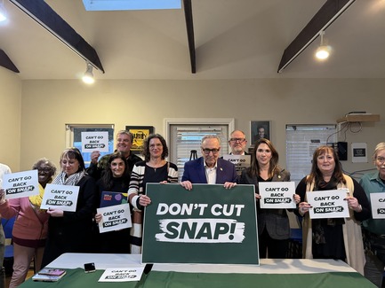 County Executive Metzger with Senator Schumer, State Senator Hinchey, and other local leaders holding "don't cut SNAP signs"