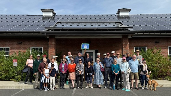 County Executive Metzger and a group celebrating the solar panels on the New Paltz fire station
