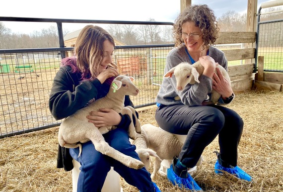 County Executive Metzger and Ripley holding lambs at Willow Pond sheep farm